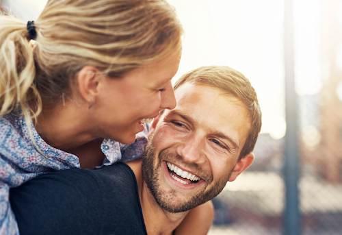 Couple smiling after invisalign treatment