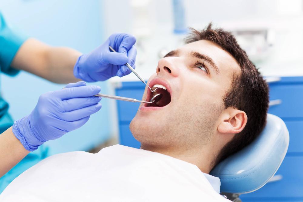 man getting dental cleaning in etobicoke dental office