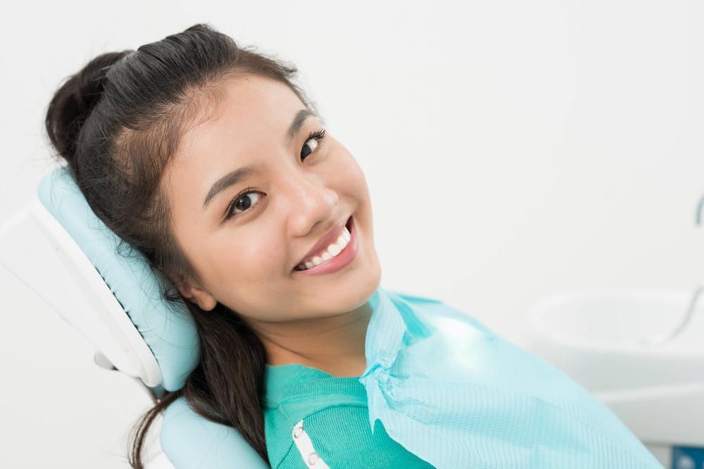 Woman smiling in dental chair before exam