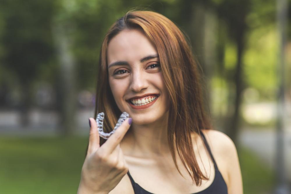 woman holding invisalign in etobicoke