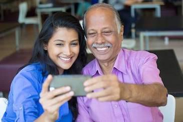 daughter and father smiling while taking a selfie