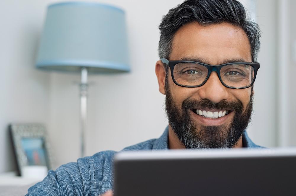 Man smiling over laptop