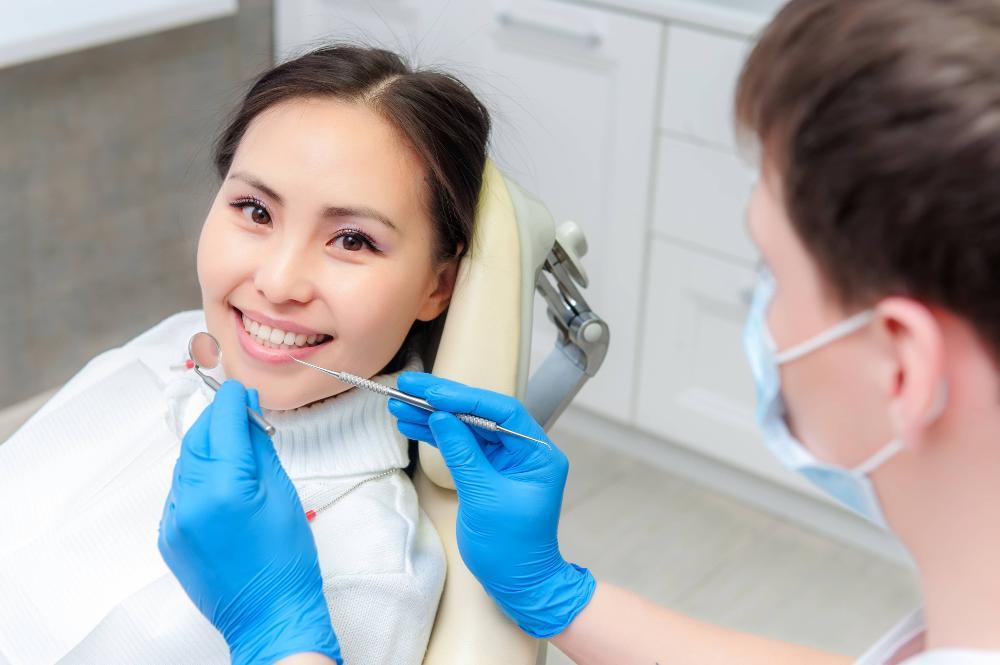 woman smiling while getting periodontal treatment in etobicoke