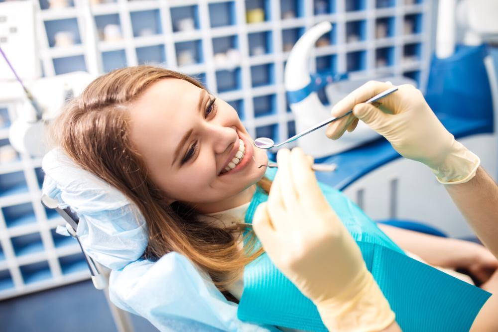 woman smiling in dental chair after root canal treatment in etobicoke