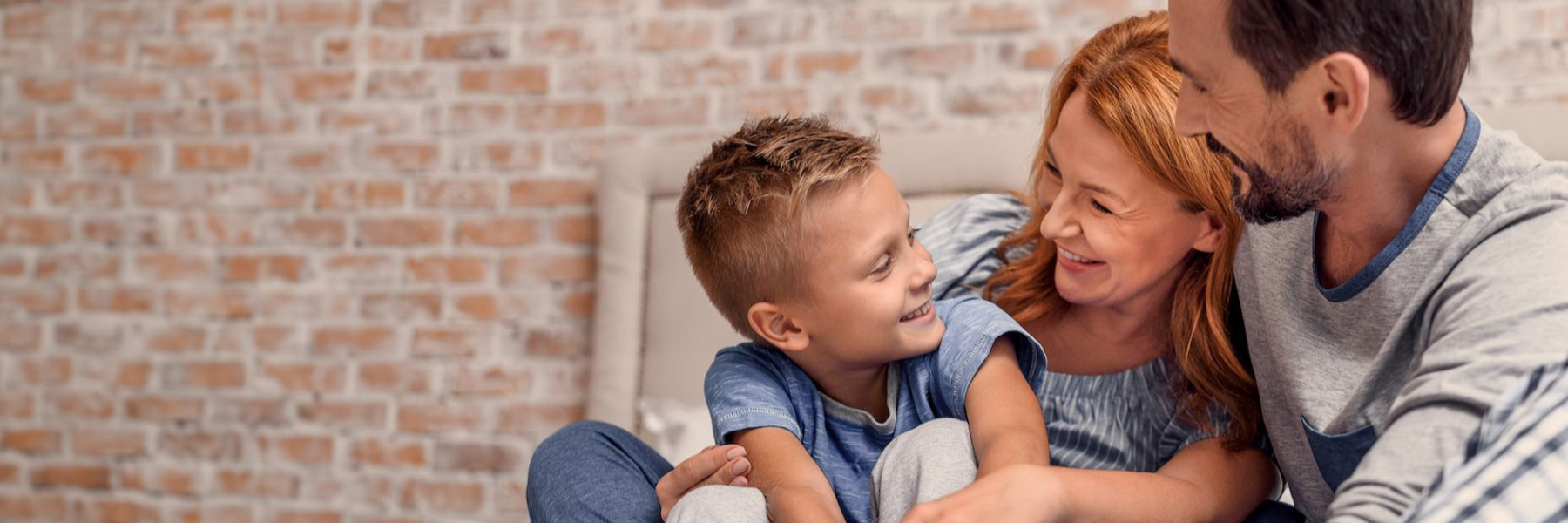 etobicoke mother, father, and son smiling