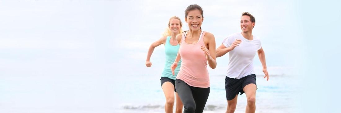 adults running on beach in toronto