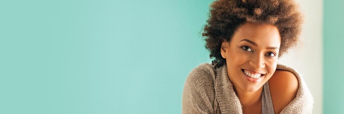 toronto Woman smiling with blue background