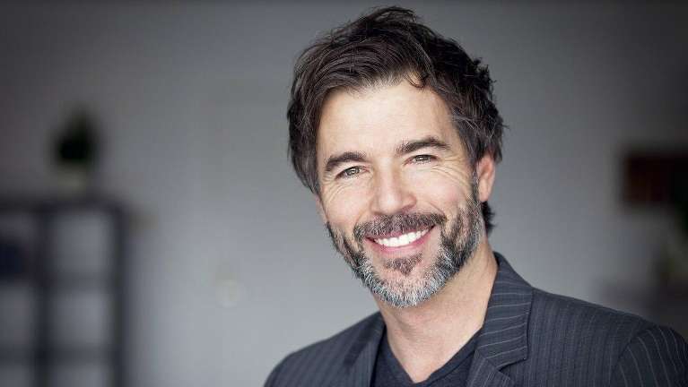 man smiling after getting dental implants in etobicoke