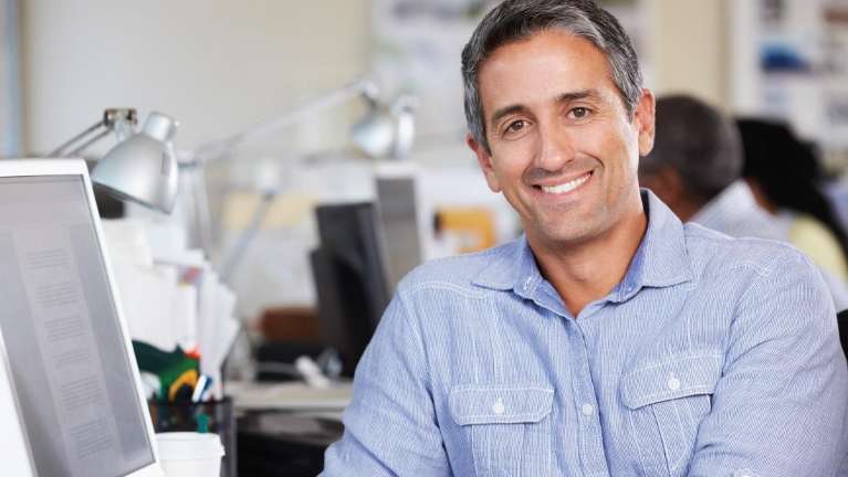 man smiling after getting implants from etobicoke
