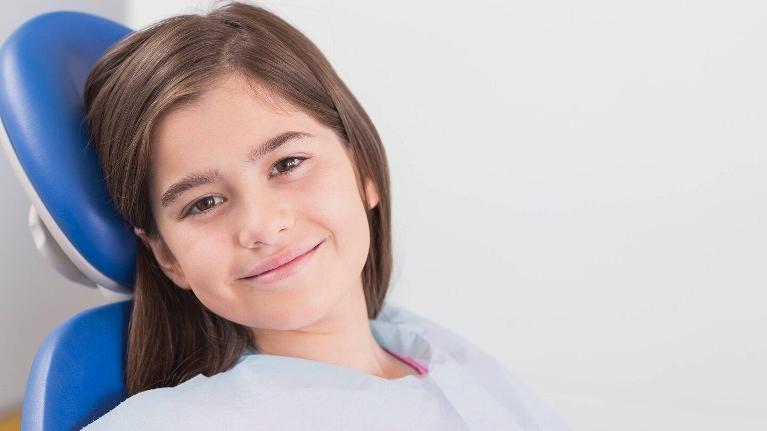 young girl smiling in dental chair in etobicoke