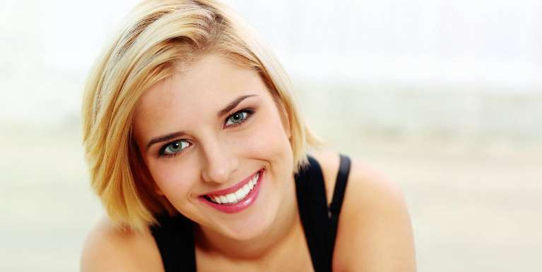 woman smiling after getting dental veneers in toronto