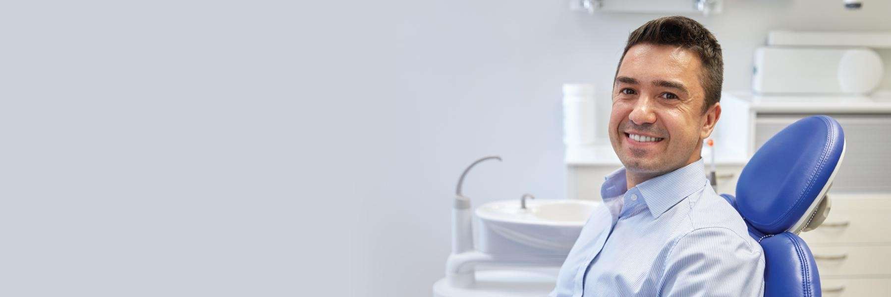 man smiling in toronto office after dental exam