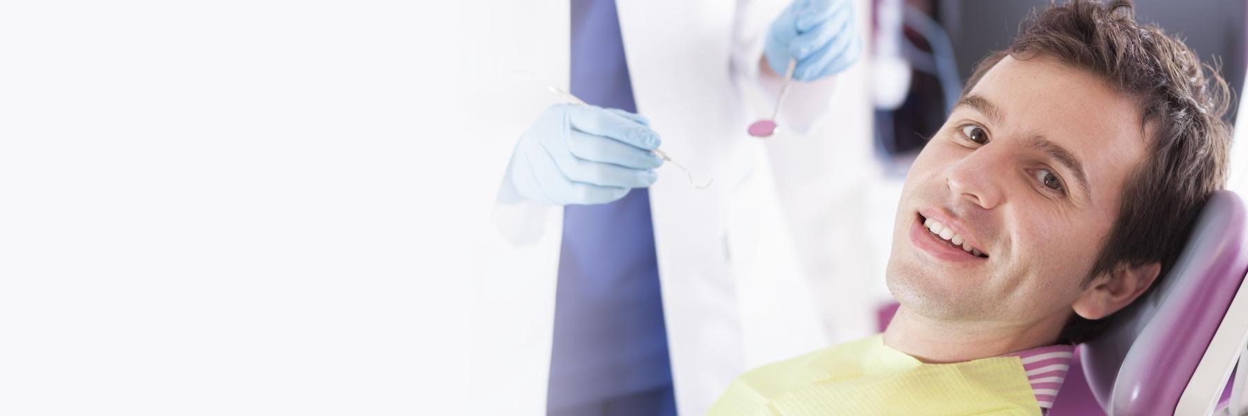 Man smiling in dental chair in Toronto dental office