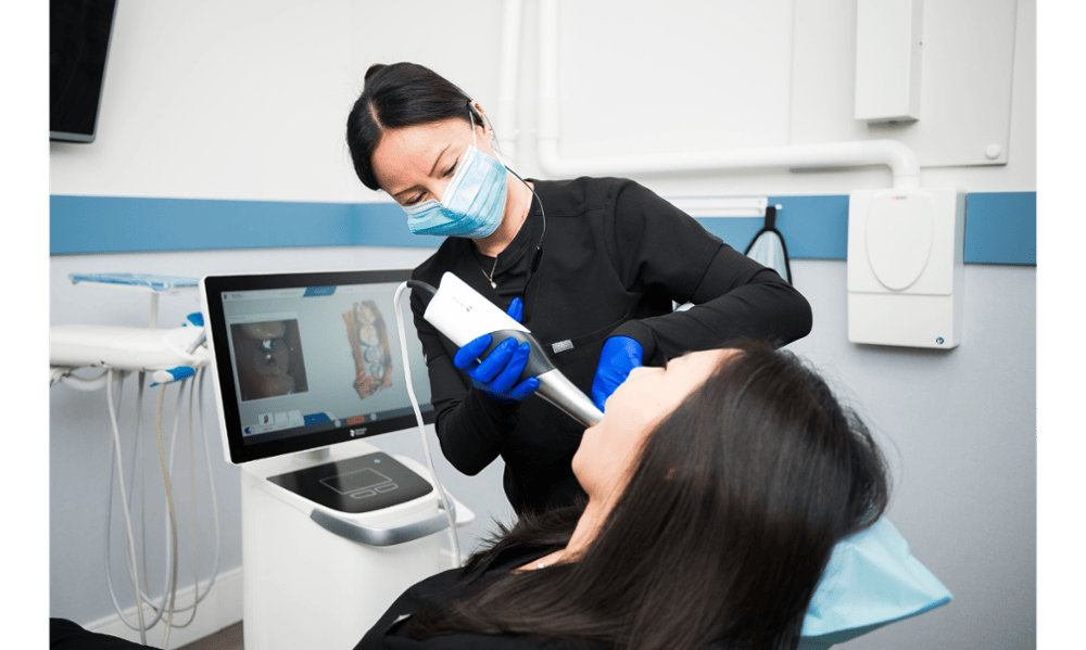 Dental professional using digital scanning technology during a patient visit in etobicoke