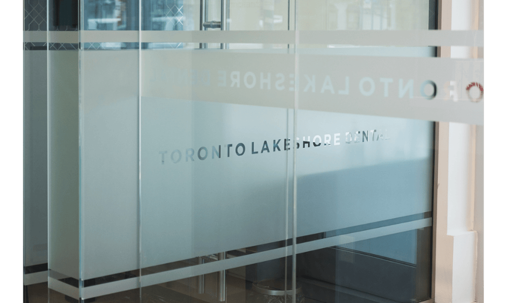 Glass entrance with Toronto Lakeshore Dental branding