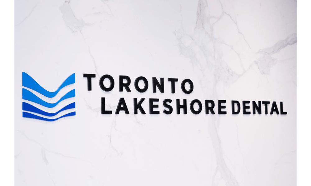 Toronto Lakeshore Dental logo on a white marble wall